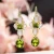 Huitan-pendientes colgantes estéticos para mujer, accesorios elegantes de compromiso de boda con perlas de imitación, joyería de fiesta CZ verde brillante con incrustaciones
